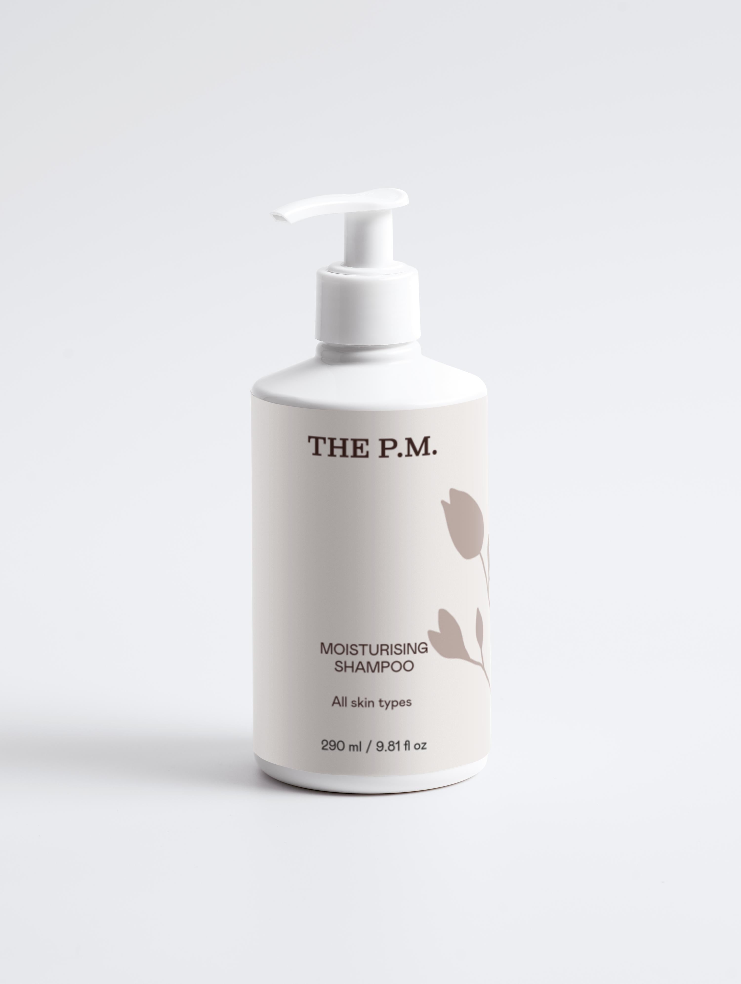 White shampoo bottle with pump labeled 'THE P.M.' on a light gray background