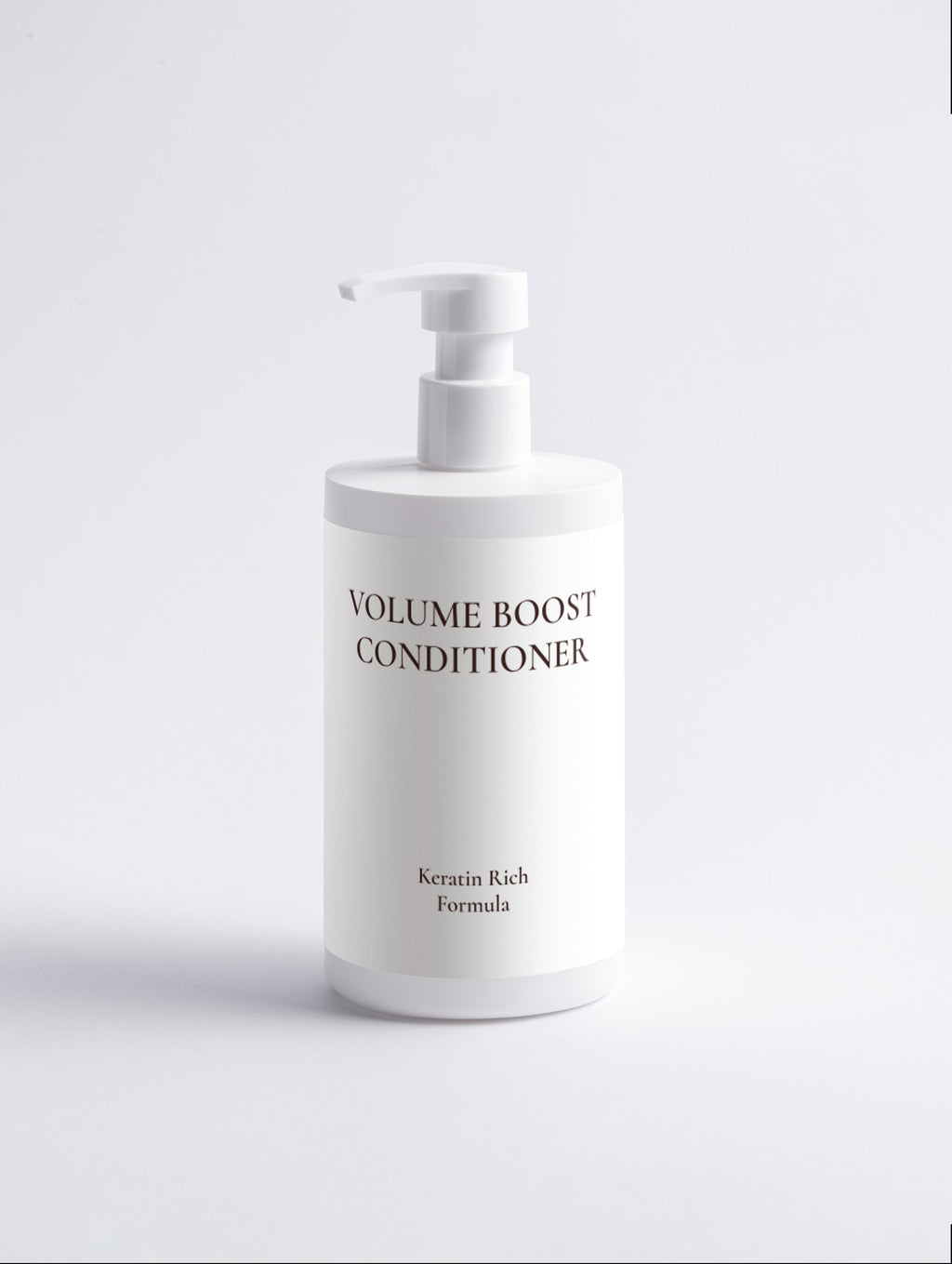 A white pump bottle of Volume Boost Conditioner with black text, set against a clean white background.