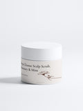 Jar of scalp scrub with text on a white background